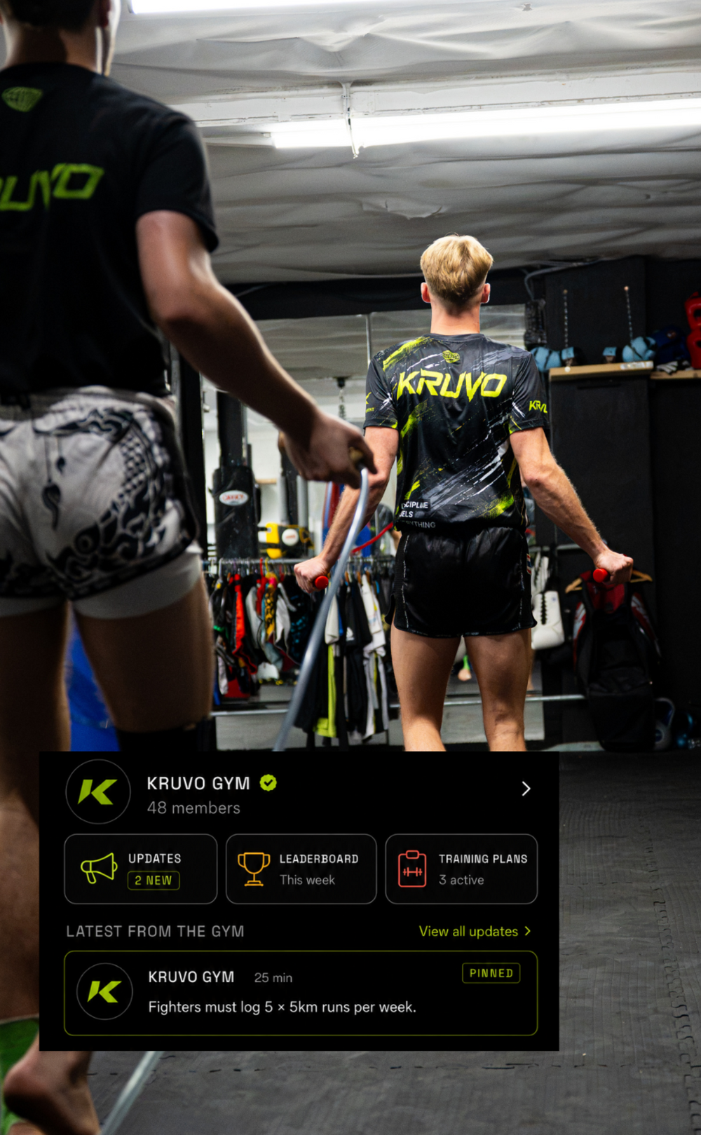 A person wearing a black and neon green Kruvo gym jersey stands in a gym interior, with other people partially visible in the foreground and gym equipment in the background. A promotional graphic overlay for Kruvo Gym is shown at the bottom left.