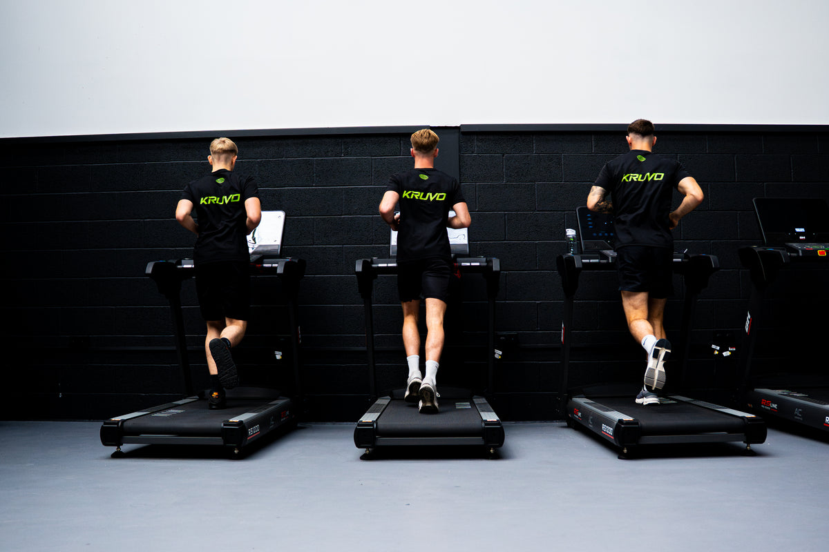 Three athletes in KRUVO tops running on treadmills
